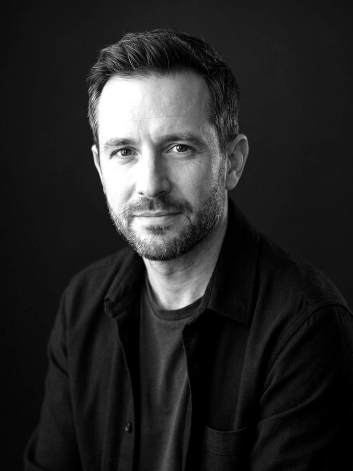 Max, Envoy's built-in AI avatar: a fictional man in his early forties, in black and white.
